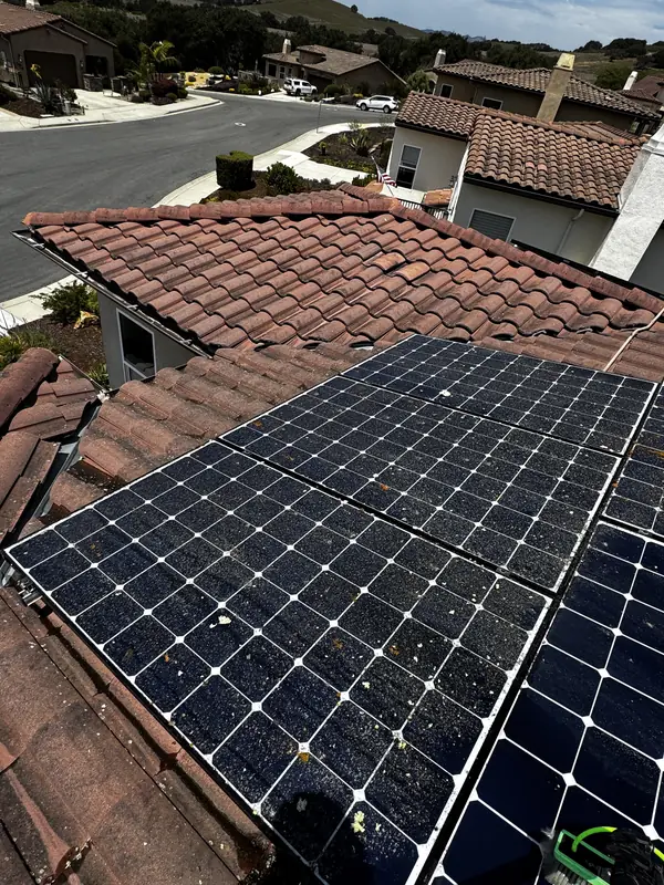 Before: Rooftop solar panels before cleaning, covered in dust and bird droppings