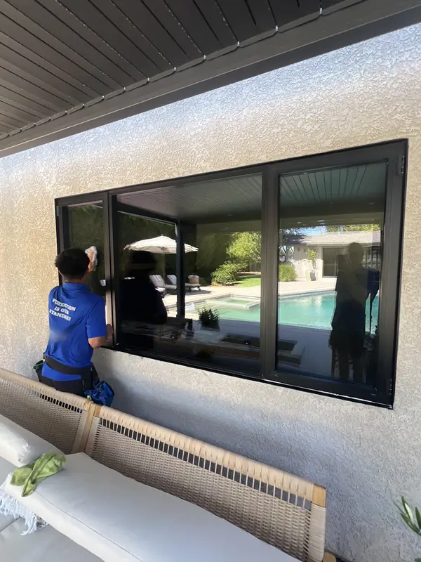After: A streak-free patio window reflecting the backyard pool after a High Tide window cleaning, window cleaning in Avila Beach, CA